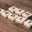 Scrabble tiles on brown table, spelling out SEO audit