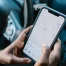 person using Google maps on smartphone while in car