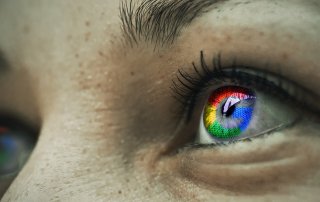 Google logo reflected in person’s eyes
