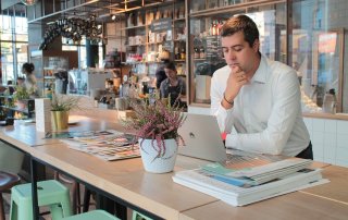 business man working in cafe, looking at laptop