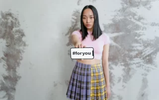 social media influencer holding smartphone displaying “for you” message