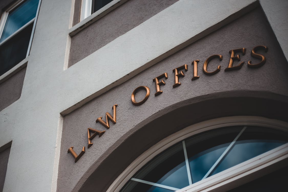 law offices sign over arched window