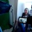 video camera filming content, subject on sofa
